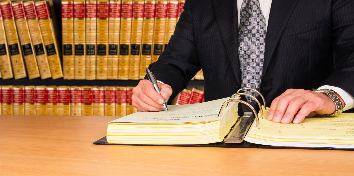 lawyer-signing-legal-documents-policyfind