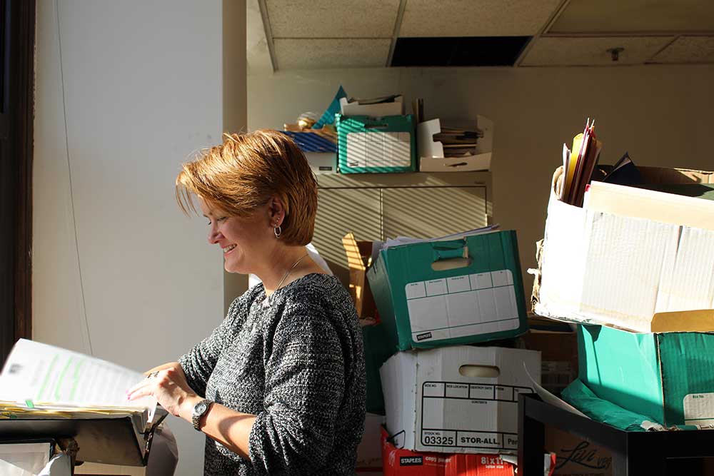 woman looking through old files 